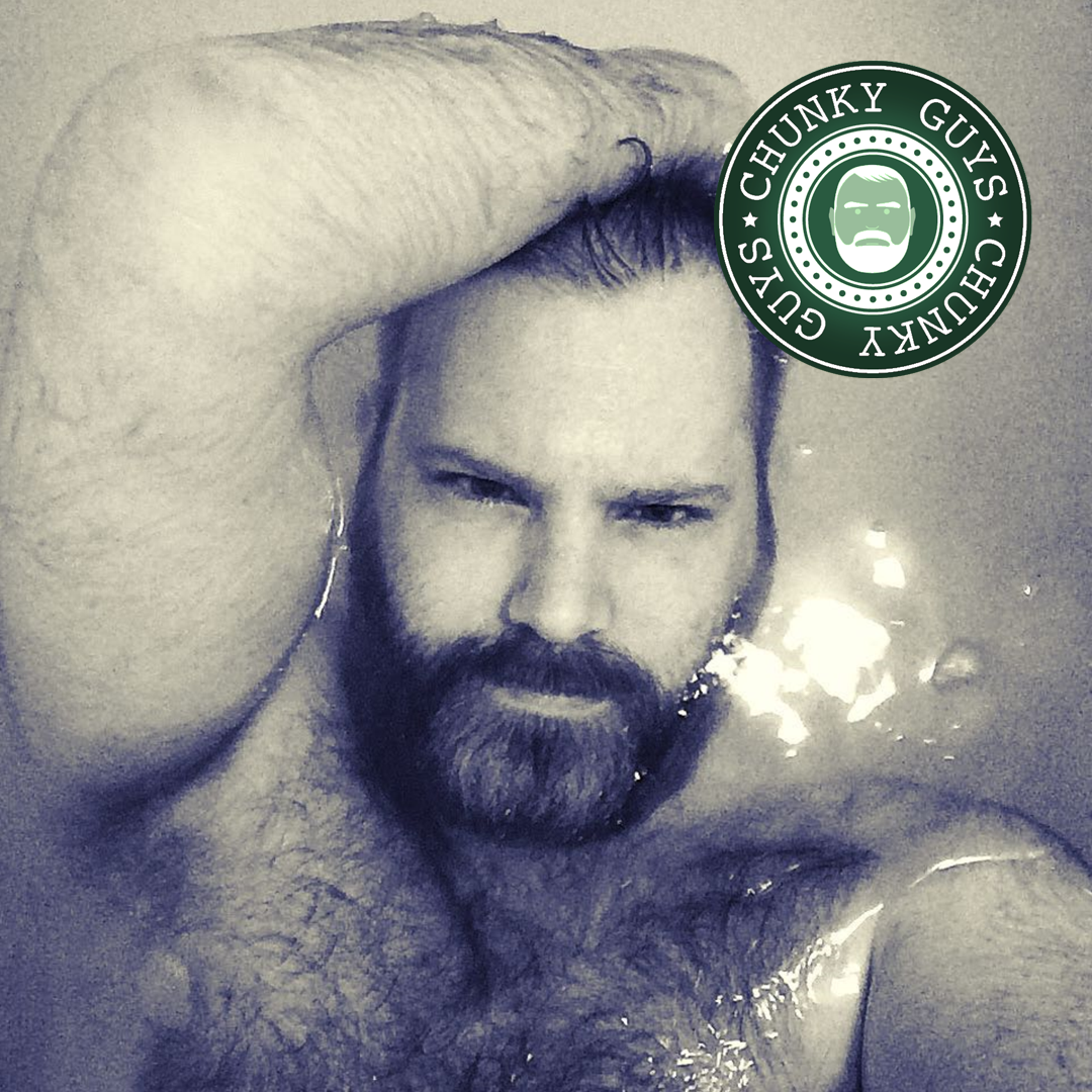 Black and white photo of hairy bearded guy taking a bath