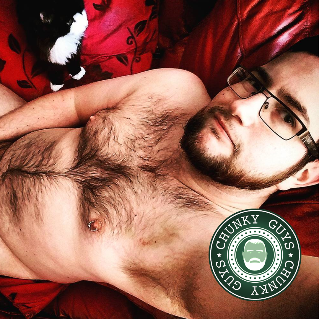 Young cubby guy with a hairy chest wearing glasses