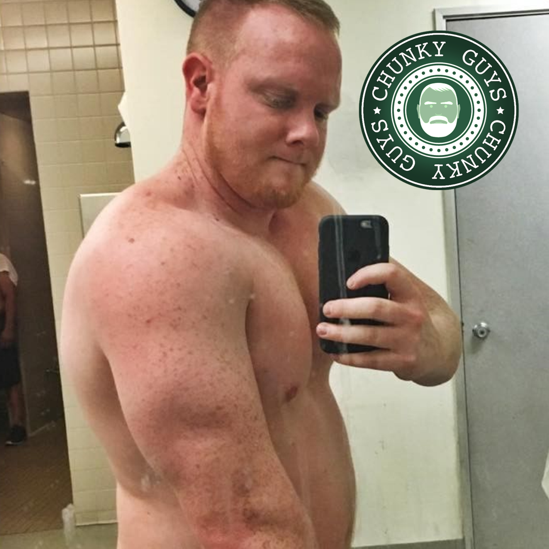 Ginger muscle cub flexing his tricep in the mirror