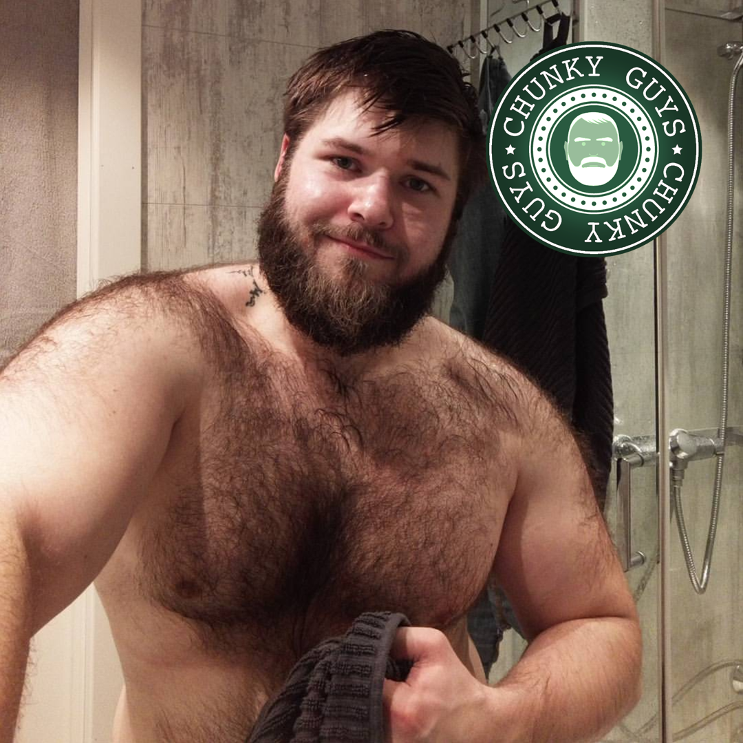 Hairy brown bearded young chunky guy just fleshly showered holding a towel